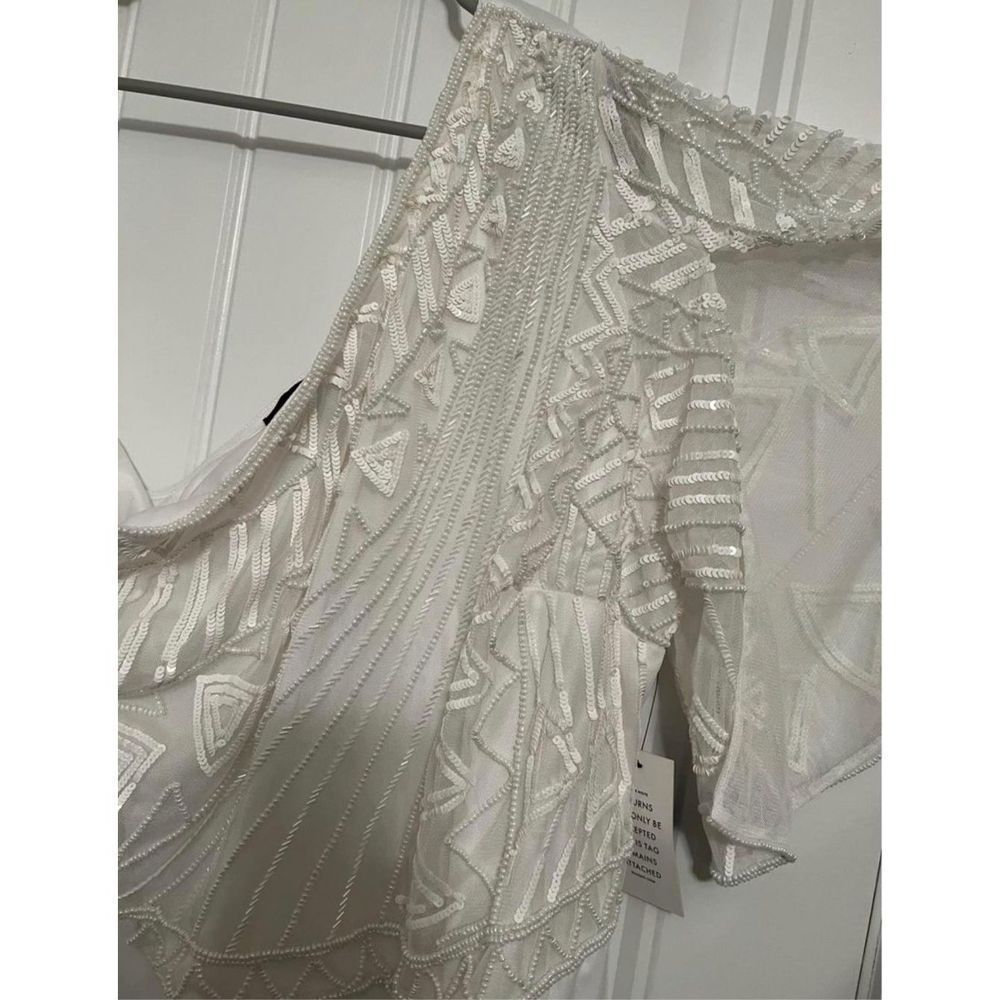 One shoulder white jumpsuit from Eloquii.
Size 18
Beaded detail on top.
Purchase - Picture 9 of 11